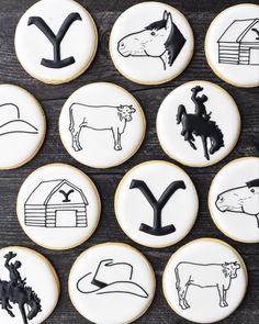 twelve decorated cookies with farm animals and symbols on them, all in black and white