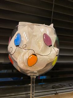 a wine glass that has some decorations on it