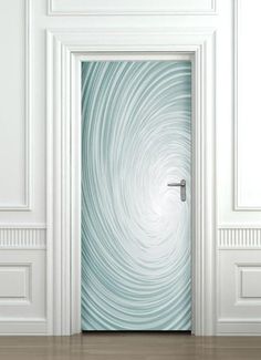 an open door with a swirl design on the glass in front of white walls and wood flooring