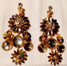 Chunky and unique Flower Cluster Clip On Earrings These are vintage Earrings in great condition These hang 3.5 inches Gold flower design with shiny crystal centers The clip on closure is new as well but very well made and has a good clasp These are chunky but very lightweight Very classy and timeless Earrings Gold Flower Design, Small Pearl Earrings, Wood Hoop Earrings, Timeless Earrings, Types Of Earrings, Flower Cluster, Unique Flower, Disc Earrings, Rhinestone Flower