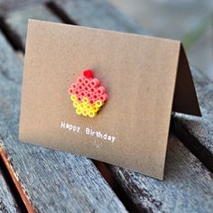 a happy birthday card sitting on top of a wooden bench