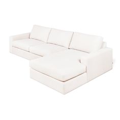 a white sectional couch sitting on top of a white floor