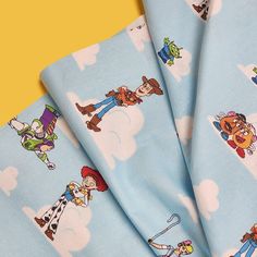 four blue sheets with cartoon characters on them