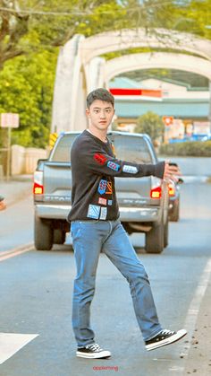 a young man riding a skateboard across a street