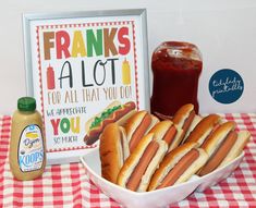 hotdogs and ketchup on a table with a sign that says franks a lot for all that you do