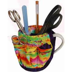 a cup filled with scissors and other items