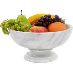 a marble bowl filled with assorted fruit