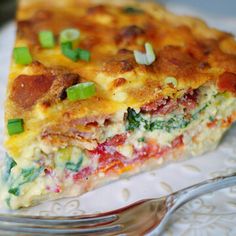 a slice of quiche on a plate with a fork