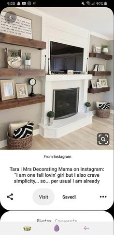 a living room with shelves and pictures on the wall, in front of a fireplace