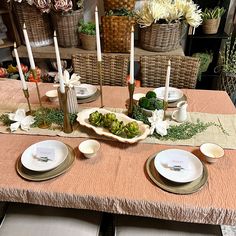 the table is set with dishes and place settings