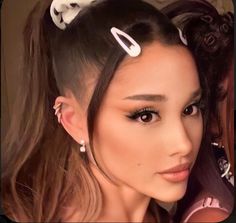 two women with hair clips on their heads posing for the camera, one is wearing a pink top