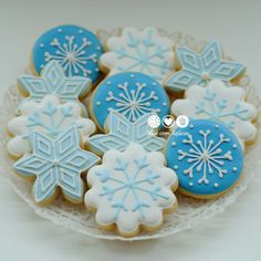 cookies decorated with blue and white icing on a plate