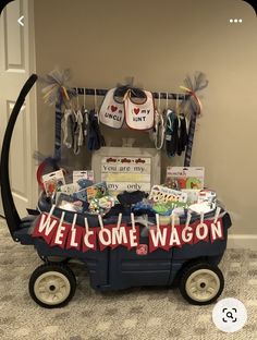 a wagon filled with baby items sitting on top of a carpeted floor next to a door