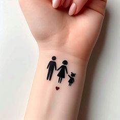 a woman's hand with a tattoo on it that has the image of a family holding hands