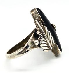 Navajo Black Onyx Feather RG sterling silver Native American vintage ring. Good used condition with little signs of normal wear. Great vintage patina present. Stamped RG Sterling on the back of the stone. Long black onyx is bezel set between two handcrafted Navajo feathers. Acid tests positive for sterling silver. Ring measures size 6 and 1/2. Edwardian Onyx Rings, Vintage Onyx Ring, Native American Vintage, Black Onyx Ring, Onyx Ring, Vintage Ring, Long Black, Caribbean Netherlands, Black Onyx