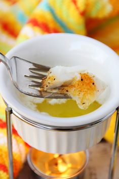 a small white bowl filled with food on top of a table