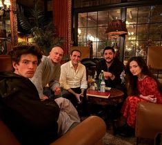 four people sitting around a table in a room