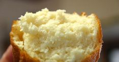 a close up of a person holding a piece of bread