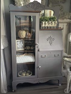 an old china cabinet is painted gray