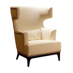 an upholstered white chair with studded trimmings on the arms and back