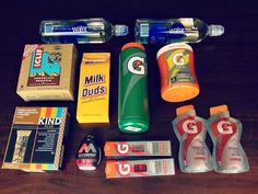 the contents of an emergency kit laid out on top of a wooden table, including toothpaste and mouthwash