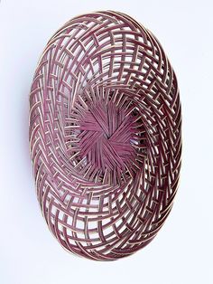 a purple basket sitting on top of a white table