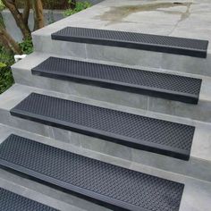 the steps are made of concrete and have black treads