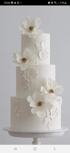 a white wedding cake with flowers on it