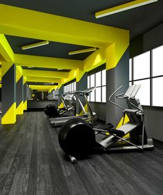 an empty gym with treadmills and exercise machines