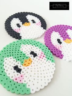 three penguin coasters made out of perler beads