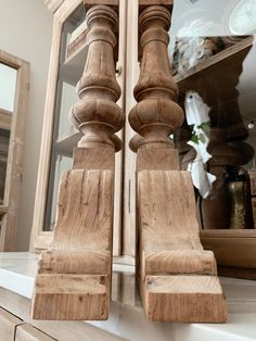 a close up of a wooden object on a counter with a mirror in the background