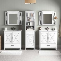 a white bathroom with two sinks and mirrors