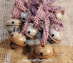 an arrangement of wooden bells and star decorations on burlocked fabric with bows