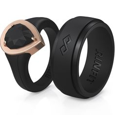 two black and rose gold wedding rings, one with a diamond in the center on each side