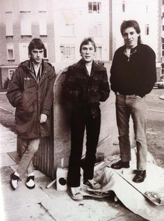 three young men standing next to each other