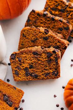 slices of chocolate chip pumpkin bread on a white surface