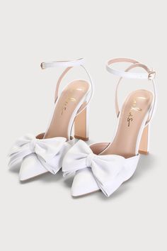 Grab a chic addition like the Lulus Penson White Bow Pointed-Toe Ankle Strap Pumps to elevate anything from an evening ensemble to your special day look! Smooth faux leather shapes a single sole silhouette and a classic pointed-toe upper, adorned with an oversized bow detail. Two long straps sprout from the sides and secure around the ankle with a shiny gold buckle, all atop a trendy blade heel. 4" wrapped blade heel. Cushioned insole. Rubber sole has nonskid markings. All Man Made Materials. Im Prom Heels Pearl, Bridal Low Heels, Bow Heels White, White Heels With Ribbon, White Shoes With Bow, Bow Bridal Shoes, Pointy White Heels, White Closed Heels, Aesthetic White Heels