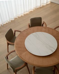 a wooden table with four chairs around it