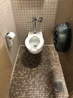 a public restroom stall with a toilet and urinal