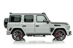 a white jeep with red rims parked in front of a white background