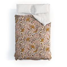 an image of a bed with white linens and brown floral pattern on the comforter