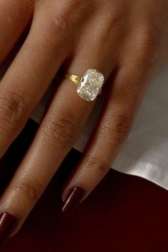 a woman's hand with a diamond ring on it