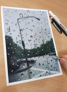 someone is holding an umbrella in the rain while it's being drawn on paper