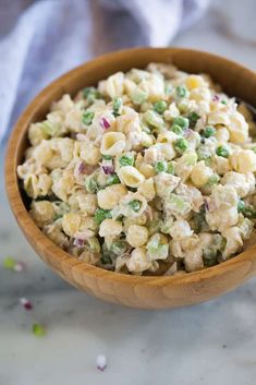 a wooden bowl filled with macaroni salad