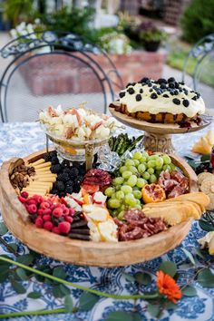 two trays filled with different types of food on top of a blue table cloth