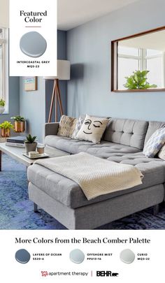 a living room with blue walls and gray furniture in the center is an advertisement for behr