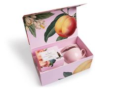 a pink box with peaches and tea in it