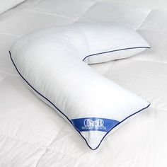 two pillows on top of a bed with white sheets and blue piping around the edges