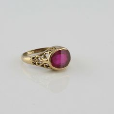 10K Yellow gold Ruby Synthetic Ring, cushion shaped stone, bezel set wear commensurate with age, S and C curls, cutouts to sides, 3/8 inch across, ring size 5.5, Circa 1920, 2.13 grams SKU# BB280R21 This listing contains photographs of the actual item you will receive. Our items are in excellent condition with little or no signs of wear and many are one of a kind pre-owned estate finds. Please look closely at the pictures in this listing as they are part of the product description. Please read t Antique Cushion Cut Rings For Formal Occasions, Antique Gold Ruby Ring With Bezel Setting, Gold Signet Ring With Accent Stones For Formal Occasions, Formal Gold Signet Ring With Accent Stones, Vintage Cushion Cut Rings For Formal Occasions, Vintage Cushion-cut Rings For Formal Events, Vintage Oval Jewelry With Bezel Setting, Antique Cushion Cut Jewelry With Center Stone, Antique Cushion Cut Rose Diamonds Jewelry