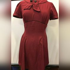 Step Back Into The Glamorous World Of The 1950s With This Stunning Hell Bunny Vixen Retro Style Party Dress In Burgundy! Perfect For Any Occasion, From Parties To Cosplay Events, This Dress Is Designed To Fit And Flatter Any Figure With Its Fit And Flare Style. The Dress Is Made From High-Quality Materials And Is In Very Great Condition, Never Used. The Dress Features A Sailor-Style Collar, Adding A Touch Of Vintage Charm To The Overall Look. The Beautiful Burgundy Colour Is Perfect For Any Seas Retro A-line Vintage Dress For Formal Occasions, Vintage Red Dress For Costume Party, Retro Vintage Dress For Retro-themed Events, Vintage Dress For Retro-themed Events, Fitted Vintage Dress For Retro-themed Events, Retro Fitted Dress For Retro-themed Events, Rockabilly Vintage Dress For Retro-themed Events, Fitted Vintage Dress In Solid Color, Formal Fitted Vintage Dress